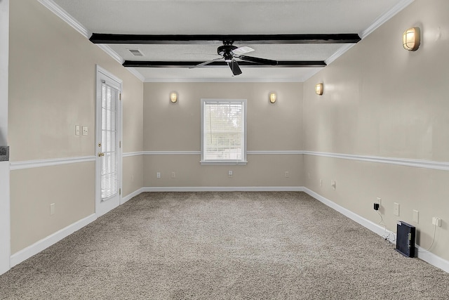 spare room with carpet, beam ceiling, and ornamental molding