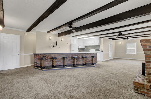 living room featuring light carpet, crown molding, and beamed ceiling