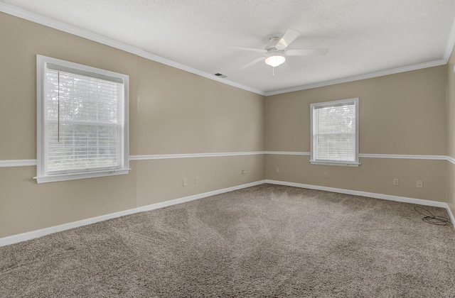 carpeted spare room with ceiling fan and ornamental molding