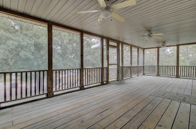 unfurnished sunroom featuring ceiling fan