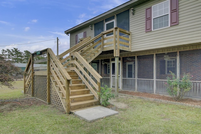 rear view of property with a wooden deck and a yard