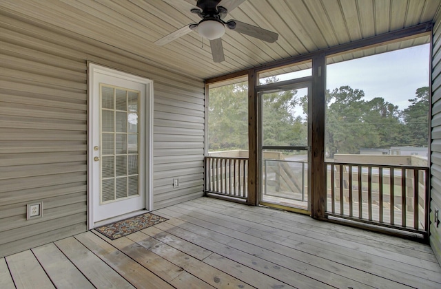 unfurnished sunroom with ceiling fan and wooden ceiling