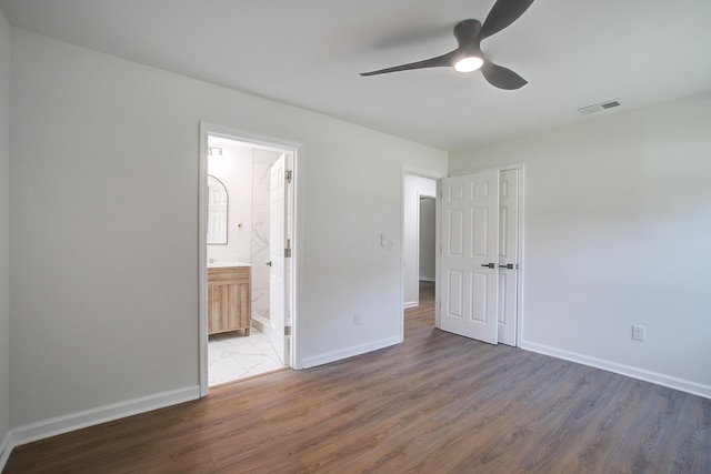 3231 Stonehaven Dr, North Charleston, SC 29420 - unfurnished bedroom with wood finished floors, baseboards, connected bathroom, and ceiling fan