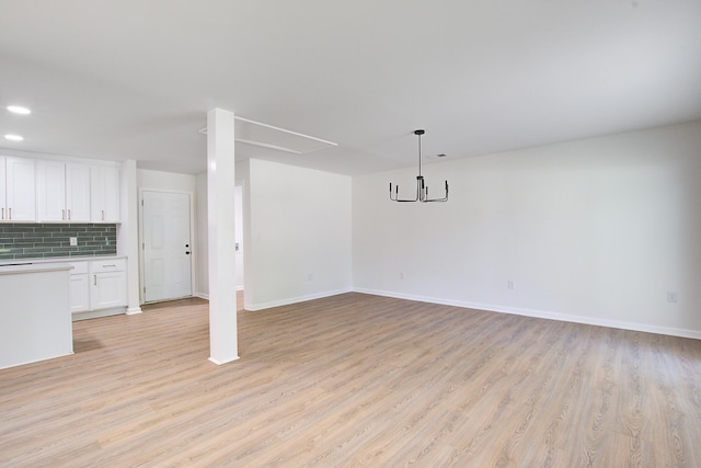 3231 Stonehaven Dr, North Charleston, SC 29420 - unfurnished living room with a chandelier, light wood-style flooring, baseboards, and recessed lighting