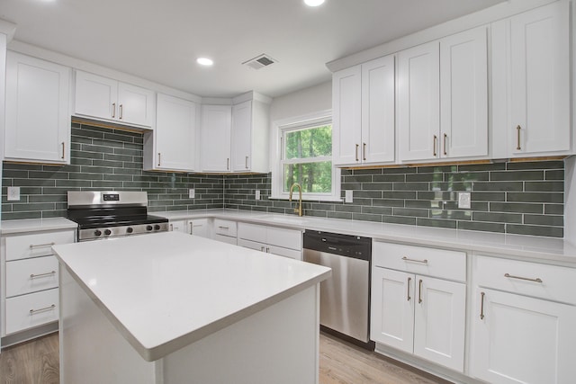 3231 Stonehaven Dr, North Charleston, SC 29420 - kitchen with stainless steel appliances, light wood-type flooring, a sink, light countertops, and white cabinetry
