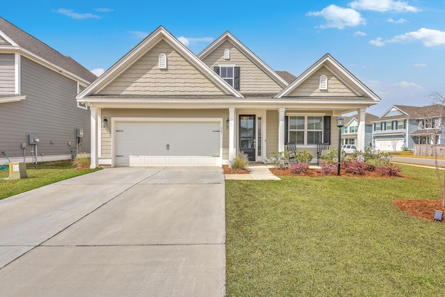 view of front of home featuring a front yard, concrete driveway, and a garage