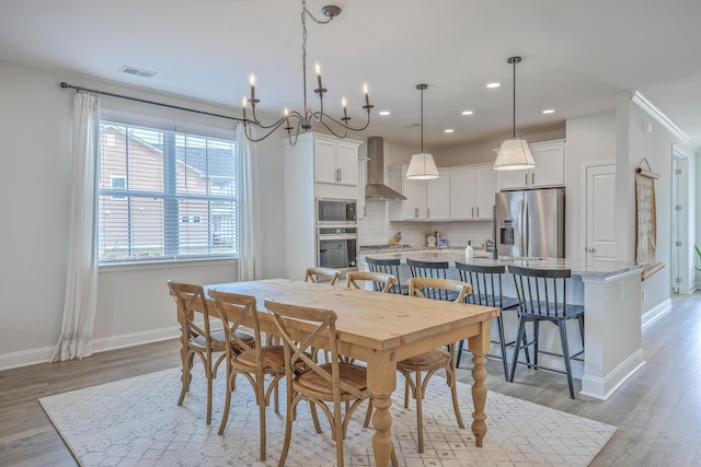 dining room with visible vents, baseboards, light wood-type flooring, recessed lighting, and a notable chandelier