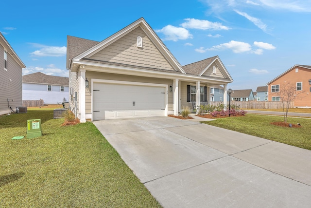 view of front of house with a garage, cooling unit, driveway, and a front lawn