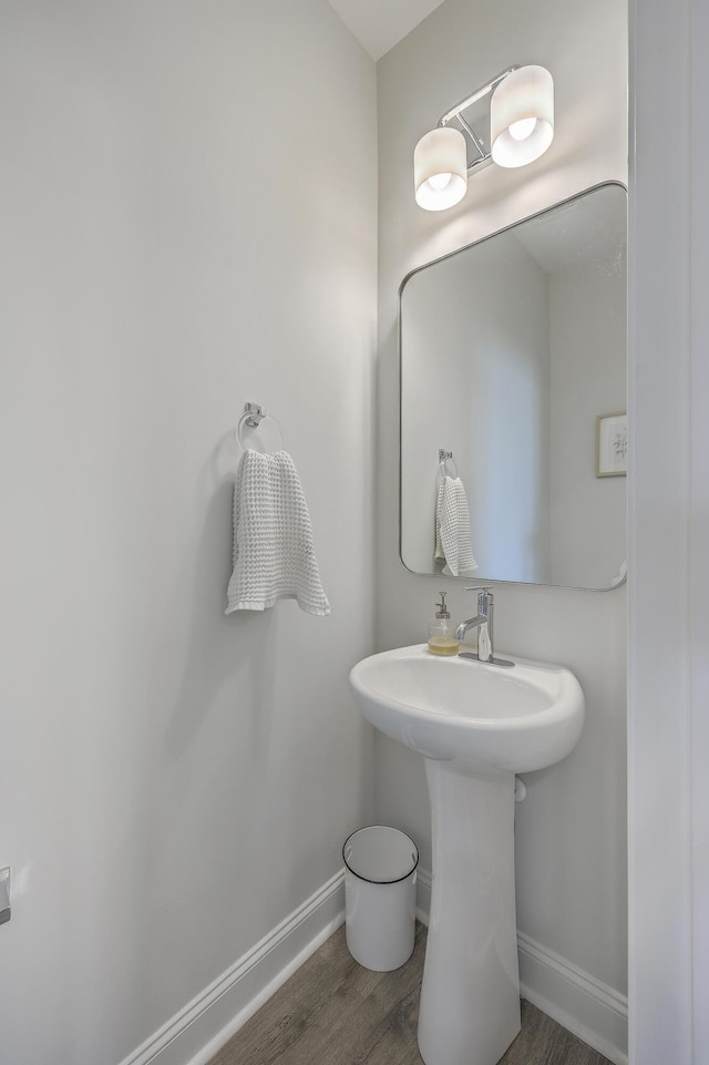 bathroom with baseboards and wood finished floors