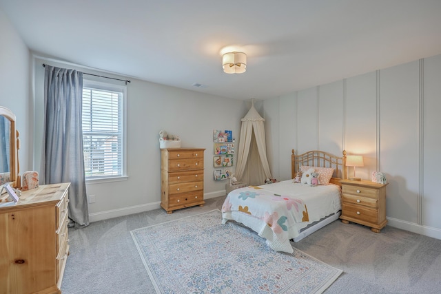 bedroom with light carpet and baseboards