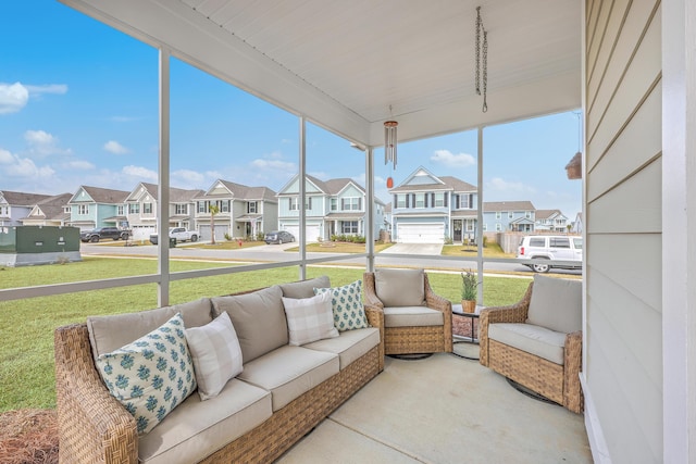 sunroom / solarium featuring a residential view and a healthy amount of sunlight