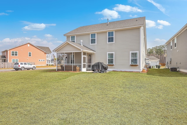 back of house with central AC, a lawn, a sunroom, and a shingled roof