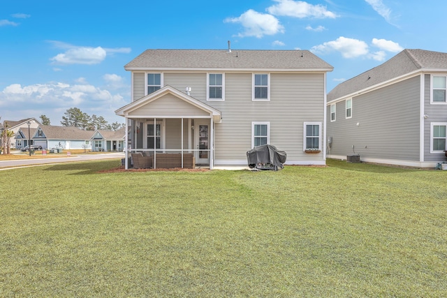 back of house featuring a lawn, cooling unit, and a sunroom