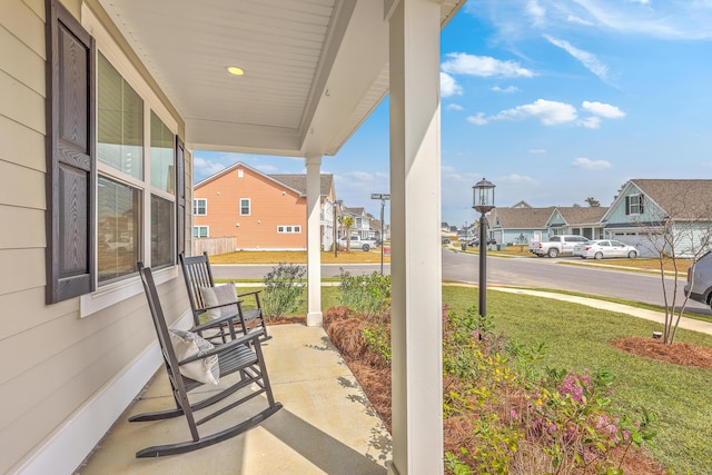 view of patio featuring covered porch and a residential view