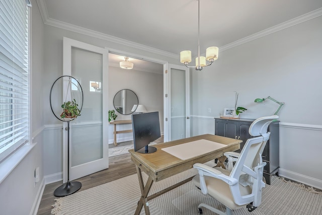 office featuring an inviting chandelier, wood finished floors, baseboards, and ornamental molding