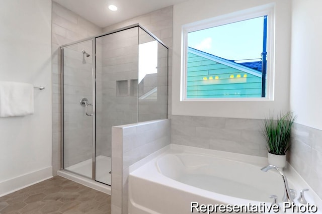 bathroom featuring tile patterned floors, a stall shower, and a garden tub