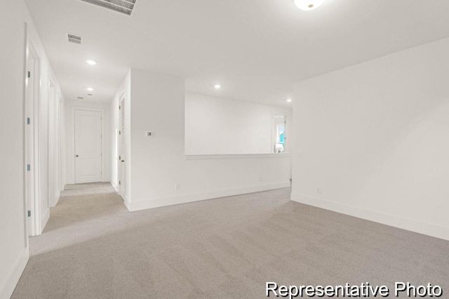 unfurnished room featuring visible vents, recessed lighting, baseboards, and carpet floors