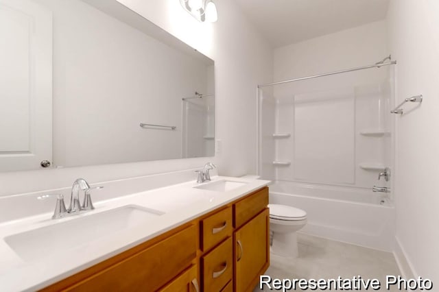 bathroom featuring a sink, washtub / shower combination, toilet, and double vanity