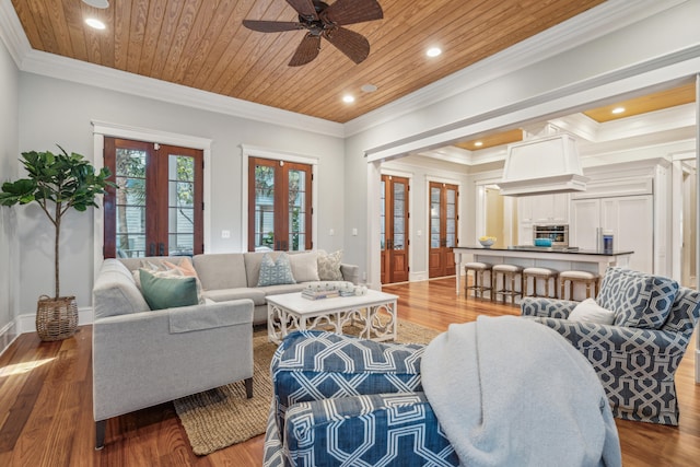 living room featuring french doors, wood ceiling, crown molding, and light wood-type flooring