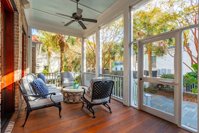 sunroom featuring ceiling fan