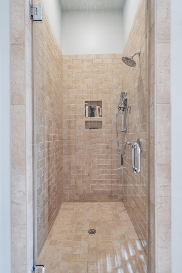 bathroom featuring a shower with shower door