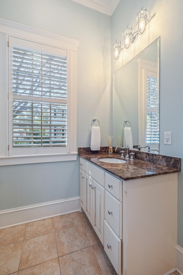 bathroom with vanity and ornamental molding