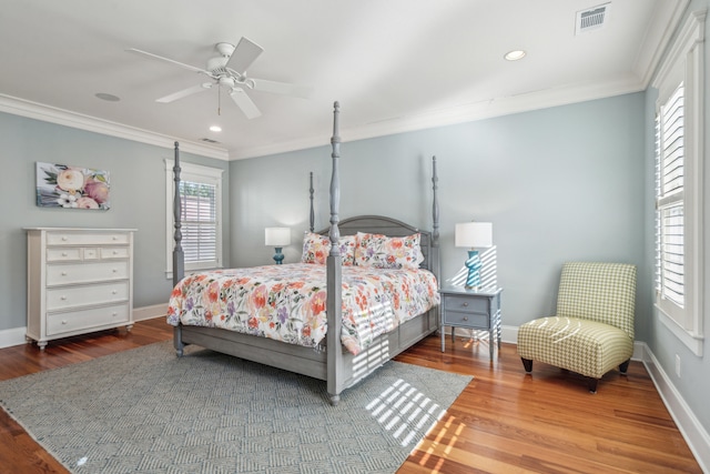 bedroom with ornamental molding, wood-type flooring, and ceiling fan