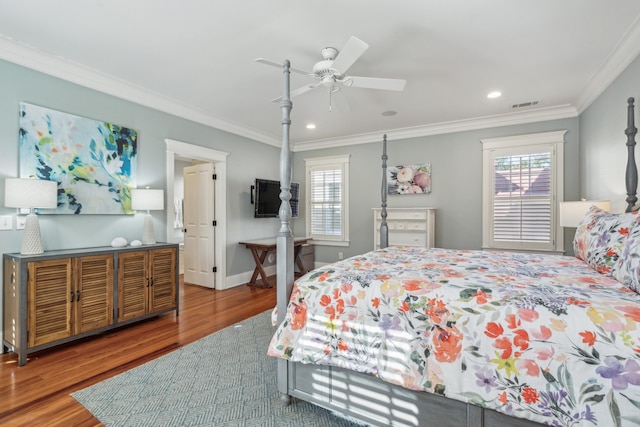 bedroom featuring ornamental molding, wood-type flooring, and ceiling fan