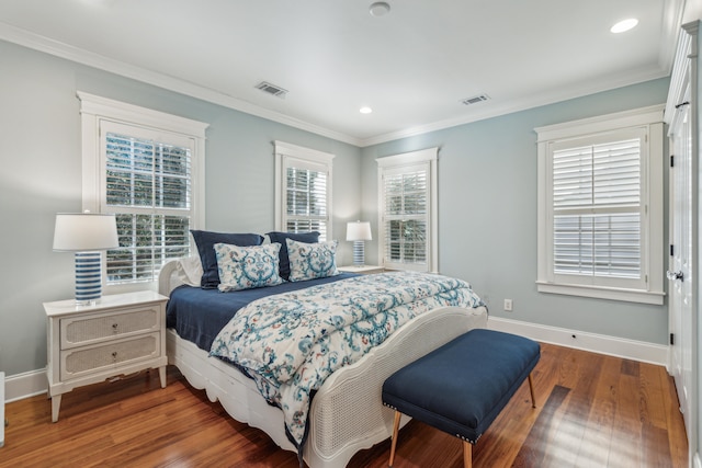 bedroom with dark wood-type flooring and ornamental molding