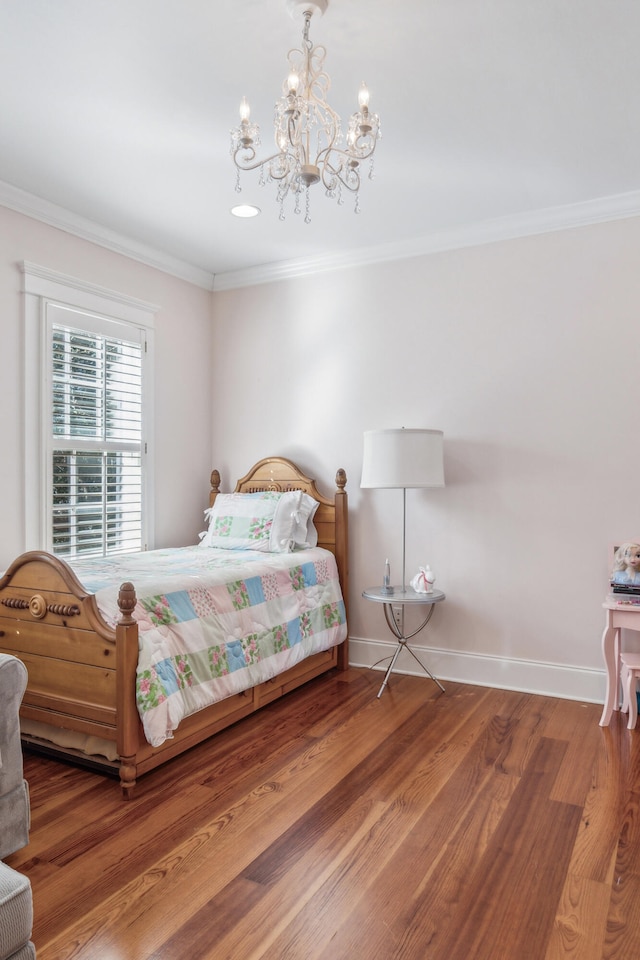 bedroom featuring crown molding, a chandelier, and wood-type flooring