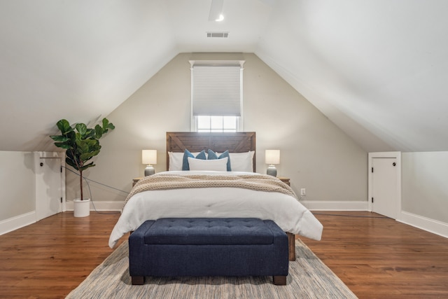 bedroom featuring lofted ceiling and dark wood-type flooring