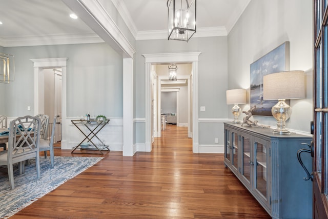 entrance foyer featuring dark wood-type flooring and crown molding