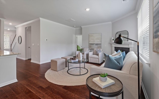 living room featuring a fireplace, baseboards, ornamental molding, dark wood-type flooring, and recessed lighting