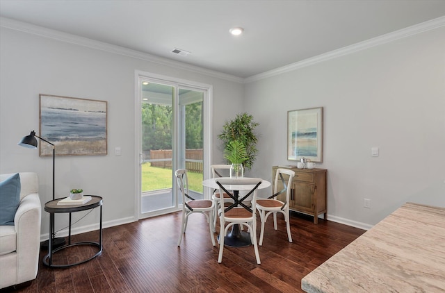 dining area featuring visible vents, crown molding, baseboards, and dark wood-style flooring