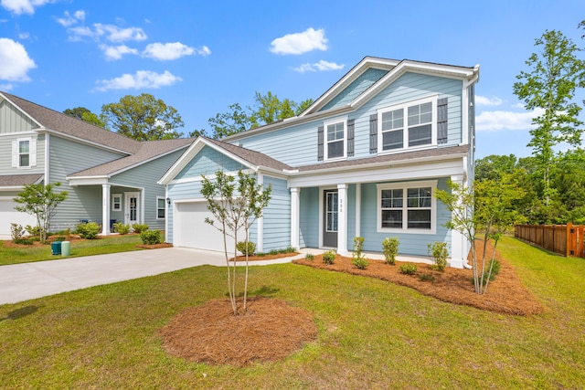 view of front of property with concrete driveway, a front lawn, an attached garage, fence, and a porch
