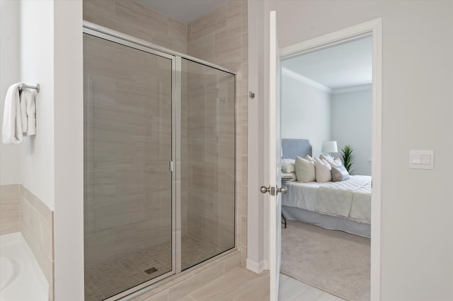 bathroom with a shower stall, a garden tub, ornamental molding, and connected bathroom