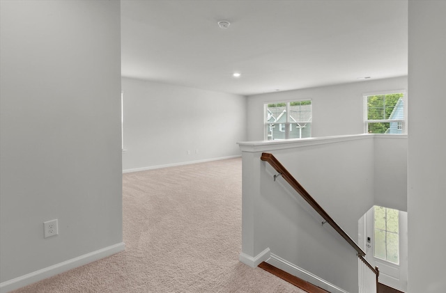 corridor with recessed lighting, carpet floors, baseboards, and an upstairs landing
