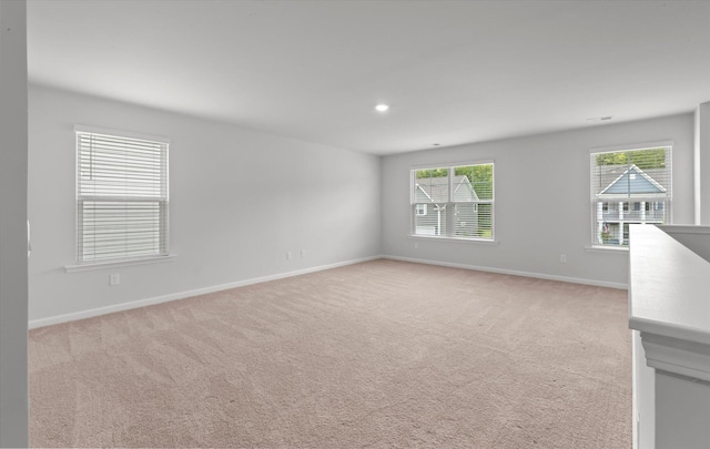 unfurnished room featuring baseboards, recessed lighting, and light colored carpet