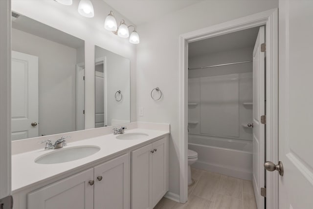full bathroom with bathing tub / shower combination, a sink, double vanity, and toilet