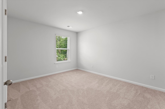 carpeted spare room with baseboards