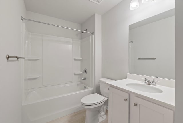 full bathroom featuring tub / shower combination, wood finished floors, toilet, and vanity