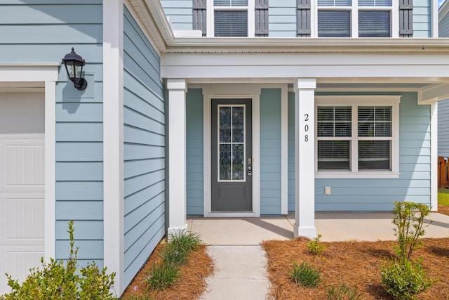 view of exterior entry featuring covered porch