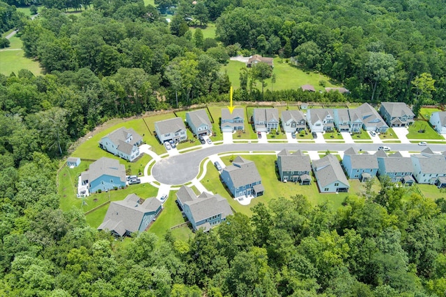 birds eye view of property with a forest view and a residential view