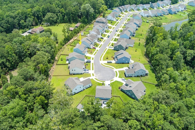 bird's eye view with a residential view, a view of trees, and a water view