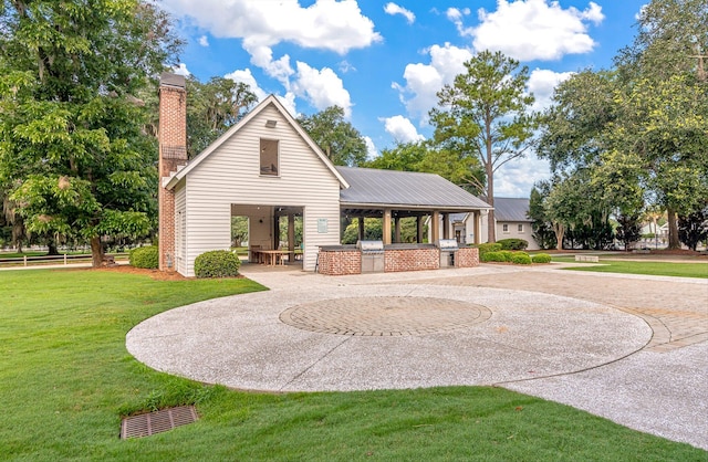 exterior space featuring a patio area and a lawn