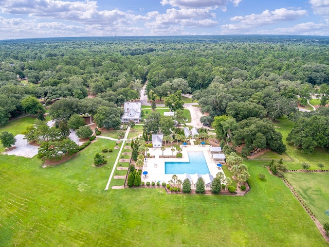 drone / aerial view with a wooded view