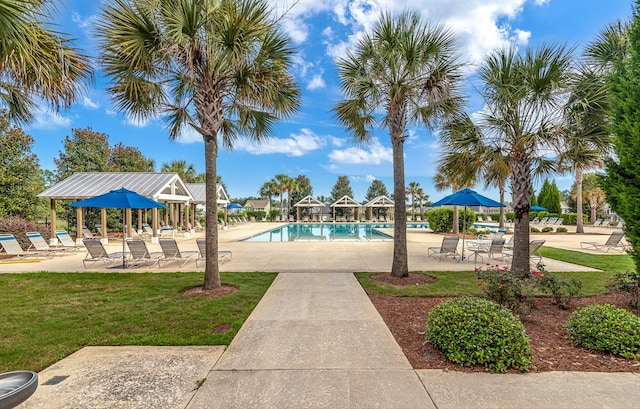 community pool featuring a yard and a patio