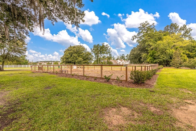 view of yard featuring a rural view and fence