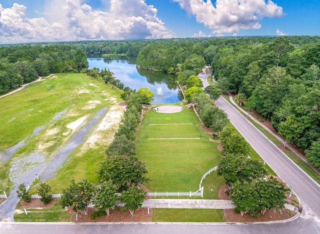 aerial view featuring a forest view and a water view