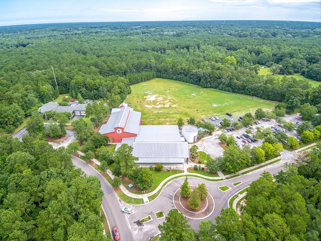 drone / aerial view featuring a wooded view